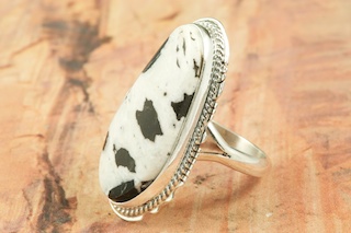 White Buffalo Turquoise set in Sterling Silver Ring. Beautiful Stone is formed from the minerals Calcite and Iron. It is mined near Tonopah Nevada. Created by Navajo Artist Larson Lee. Signed by the artist.